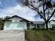 Charming home with a well-manicured lawn and a spacious two-car garage at 1470 Ne Old Mill Dr, Deltona, FL 32725
