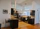 A well-lit kitchen showcases stainless steel appliances, dark wood cabinetry, and granite countertops at 1470 Ne Old Mill Dr, Deltona, FL 32725
