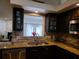 Modern kitchen with granite countertops, stainless steel appliances, and a view to the living room at 1470 Ne Old Mill Dr, Deltona, FL 32725