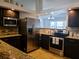 Modern kitchen with stainless steel appliances, granite countertops, and ample cabinet space at 1470 Ne Old Mill Dr, Deltona, FL 32725