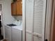 Functional laundry room features a washer, dryer, and ample storage cabinets at 1470 Ne Old Mill Dr, Deltona, FL 32725