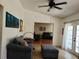 Bright living area with comfortable seating, a decorative fireplace, and open access to connecting rooms at 1470 Ne Old Mill Dr, Deltona, FL 32725