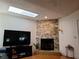 Inviting living room with a stone fireplace, TV, and cozy seating area at 1470 Ne Old Mill Dr, Deltona, FL 32725