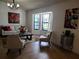 Bright living room with bay windows, neutral furniture, stylish decor, and tiled floors at 1470 Ne Old Mill Dr, Deltona, FL 32725