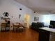Open floor plan showcasing living room, dining area, and kitchen with hardwood floors at 1470 Ne Old Mill Dr, Deltona, FL 32725
