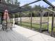 Screened patio featuring a table and chairs with access to the backyard at 1470 Ne Old Mill Dr, Deltona, FL 32725
