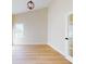 Bright bedroom with vaulted ceiling, plush carpeting, and door to outside at 804 Soft Pine Ct, New Smyrna Beach, FL 32168