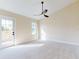 Main bedroom with ceiling fan, carpet, and door to balcony at 804 Soft Pine Ct, New Smyrna Beach, FL 32168