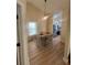 Dining room with light wood floors and a view to the kitchen at 804 Soft Pine Ct, New Smyrna Beach, FL 32168
