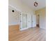 Light-filled hallway with doors to other rooms and hardwood floors at 804 Soft Pine Ct, New Smyrna Beach, FL 32168
