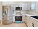 Modern kitchen with stainless steel appliances and white cabinets at 804 Soft Pine Ct, New Smyrna Beach, FL 32168