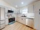 Updated kitchen featuring white cabinets and stainless steel appliances at 804 Soft Pine Ct, New Smyrna Beach, FL 32168
