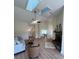 Bright living room with vaulted ceilings, skylights, and a fireplace at 804 Soft Pine Ct, New Smyrna Beach, FL 32168