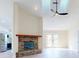 Living room with brick fireplace and vaulted ceilings at 804 Soft Pine Ct, New Smyrna Beach, FL 32168