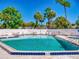 A serene community pool with lounge chairs and clear blue skies at 804 Soft Pine Ct, New Smyrna Beach, FL 32168