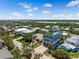 Stunning aerial view of a three story blue home with a roof top deck in a beautiful neighborhood at 1524 N Atlantic Ave, New Smyrna Beach, FL 32169