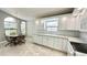 Bright kitchen with white cabinets, granite countertops, and stainless steel appliances at 806 Pine Shores Cir, New Smyrna Beach, FL 32168