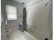 Clean bathroom with shower/tub, toilet, and white tile at 214 S Riverside Dr, New Smyrna Beach, FL 32168