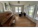Entryway with hardwood floors, a piano, and access to stairs at 214 S Riverside Dr, New Smyrna Beach, FL 32168