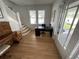 Bright entryway with hardwood floors, piano, and desk at 214 S Riverside Dr, New Smyrna Beach, FL 32168