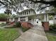 Brick house with a large front porch and a spacious lawn at 214 S Riverside Dr, New Smyrna Beach, FL 32168