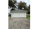 Two-car garage with white doors at 214 S Riverside Dr, New Smyrna Beach, FL 32168