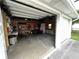 Garage interior with storage shelving and workbench at 214 S Riverside Dr, New Smyrna Beach, FL 32168