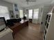 Home office with hardwood floors and large windows at 214 S Riverside Dr, New Smyrna Beach, FL 32168