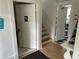 Stairwell leading to upper floor with restroom and kitchen access at 214 S Riverside Dr, New Smyrna Beach, FL 32168
