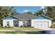 Charming single-story home with manicured lawn and a two-car garage, complemented by mature landscaping at 362 Oliver Dr, New Smyrna Beach, FL 32168