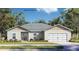 Charming single-story home featuring a two-car garage, neutral stucco, and a well-manicured front lawn at 402 Oliver Dr, New Smyrna Beach, FL 32168