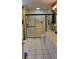 Bright bathroom with a tiled shower, glass door, and a modern vanity with ample counter space at 806 South St, New Smyrna Beach, Fl 32168, FL 32168