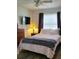 Cozy bedroom with hardwood floors, a comfortable bed, and soft natural light at 806 South St, New Smyrna Beach, Fl 32168, FL 32168