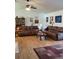 Inviting living room featuring hardwood floors, ceiling fan, and comfortable leather couches at 806 South St, New Smyrna Beach, Fl 32168, FL 32168