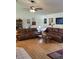 Spacious living room with hardwood floors, ceiling fan, and comfortable brown leather couches at 806 South St, New Smyrna Beach, Fl 32168, FL 32168