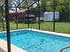 Refreshing screened-in pool area, complete with a covered boat and a convenient trailer at 806 South St, New Smyrna Beach, Fl 32168, FL 32168