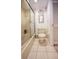 Bathroom with white tile, toilet, flamingo decor, and a glass enclosed tub and shower at 4303 Sea Mist Dr # 225, New Smyrna Beach, FL 32169