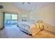 Cozy bedroom with a ceiling fan and sliding doors leading to a private balcony at 4303 Sea Mist Dr # 225, New Smyrna Beach, FL 32169