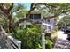 Charming exterior view with mature trees and a screened porch, perfect for enjoying the serene surroundings at 4303 Sea Mist Dr # 225, New Smyrna Beach, FL 32169