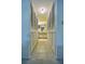 Hallway with tile flooring, white louvered closet doors, and access to the bathroom at 4303 Sea Mist Dr # 225, New Smyrna Beach, FL 32169