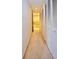 Hallway with carpet, white louvered closet doors, and access to the bathroom with a shower/tub at 4303 Sea Mist Dr # 225, New Smyrna Beach, FL 32169