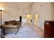 A spacious living room with high ceilings, neutral carpet, and a view of the entryway at 4303 Sea Mist Dr # 225, New Smyrna Beach, FL 32169