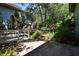 A garden patio features lush greenery and a red bench perfect for relaxing outdoors at 4303 Sea Mist Dr # 225, New Smyrna Beach, FL 32169