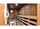 Interior view of a wooden sauna with benches and a heater, providing a relaxing wellness experience at 4303 Sea Mist Dr # 225, New Smyrna Beach, FL 32169
