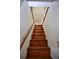 Hardwood staircase with a simple handrail leads to the upper level of the home at 4303 Sea Mist Dr # 225, New Smyrna Beach, FL 32169