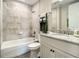 Bathroom featuring tub-shower combination and vanity with granite counter at 1 Riverwalk Dr # 202, New Smyrna Beach, FL 32169