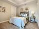 Inviting bedroom with plush carpet and decorative headboard at 1 Riverwalk Dr # 202, New Smyrna Beach, FL 32169