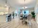 Open-concept dining room adjacent to kitchen and living area with bright natural light at 1 Riverwalk Dr # 202, New Smyrna Beach, FL 32169