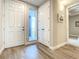 Bright hallway with wood-look tile floors, closet, and access to balcony at 1 Riverwalk Dr # 202, New Smyrna Beach, FL 32169