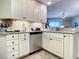 Updated kitchen featuring white cabinets, granite countertops and stainless steel appliances at 1 Riverwalk Dr # 202, New Smyrna Beach, FL 32169